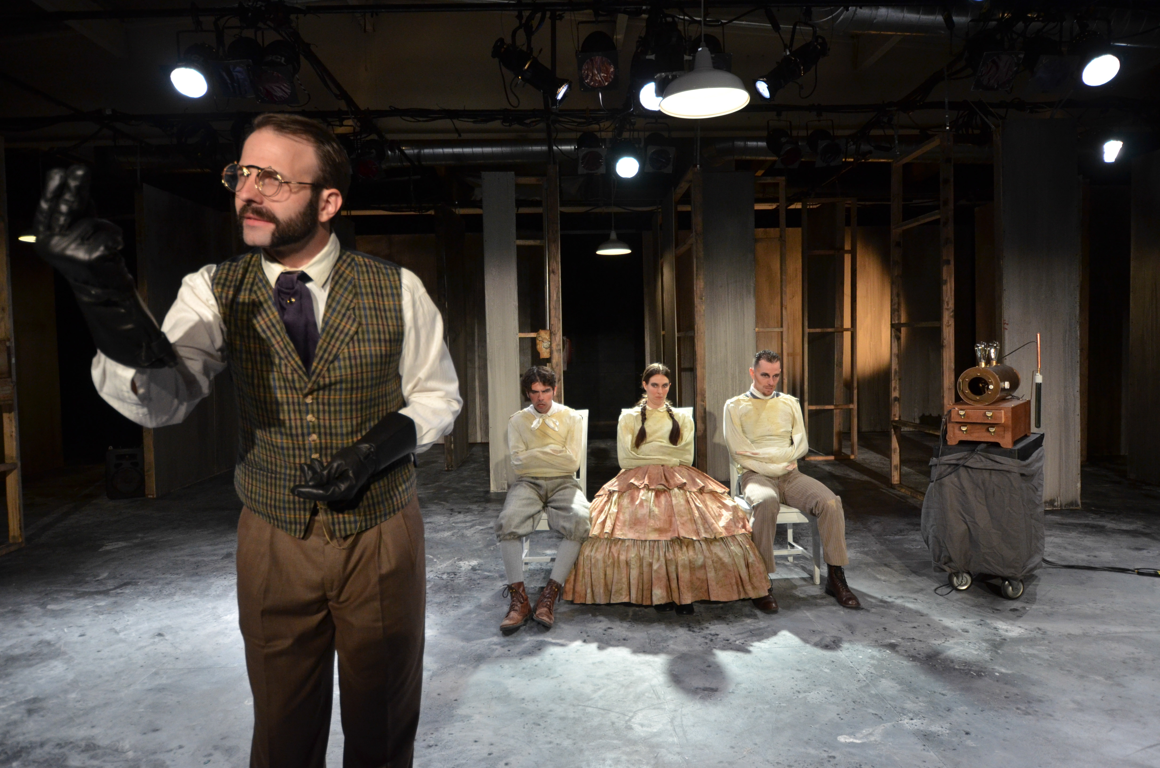 (standing) Thaddeus Shafer as DR. DUCHENNE (seated from left to right) Tyler Bremer as BON-BON, Alexis Jones as FIFI, and Andrew Eldredge as PEPE. Photo courtesy of Andrew Eiden. 